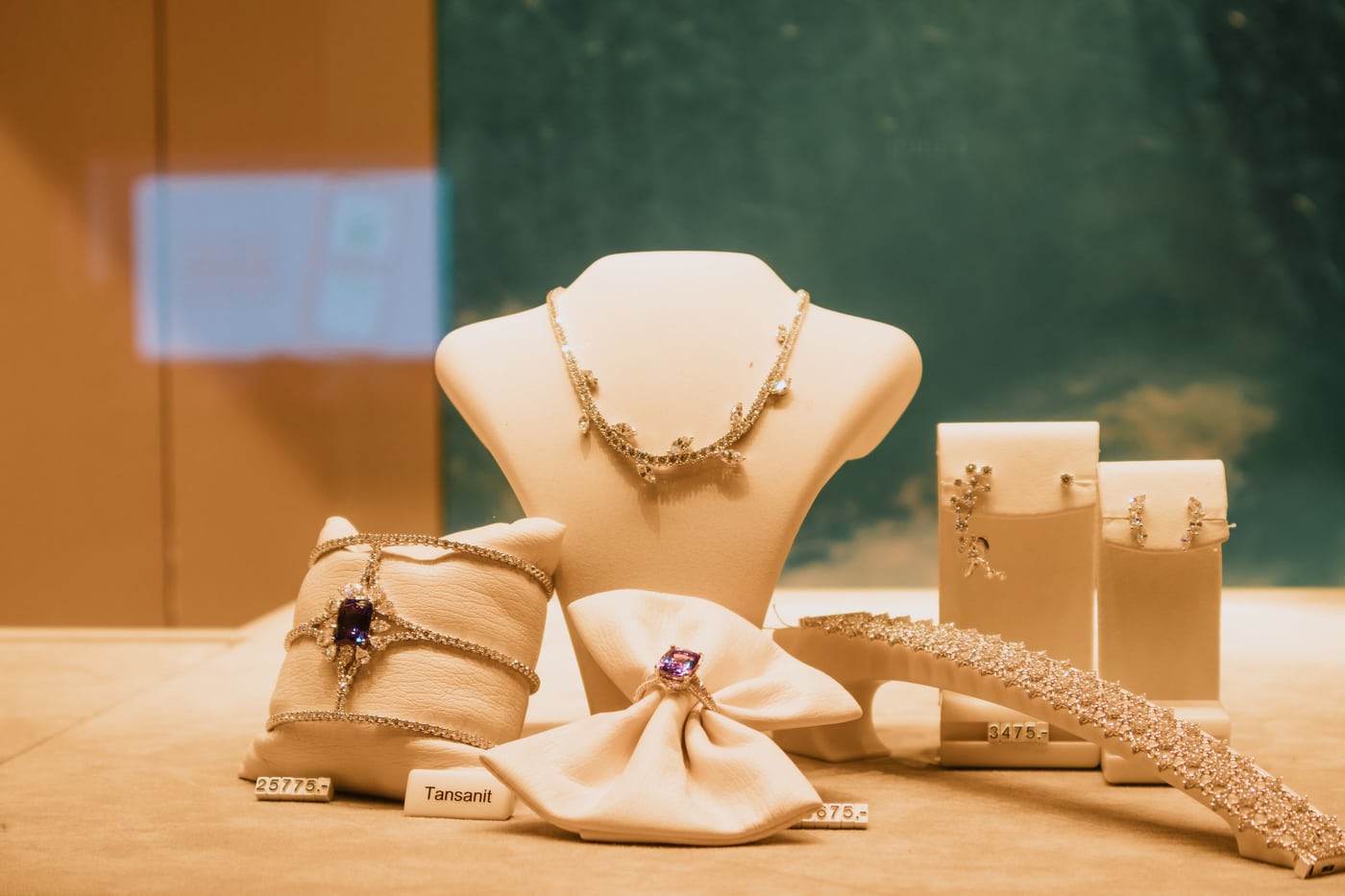 Necklaces, rings and bracelets displayed in a jewellery shop window.